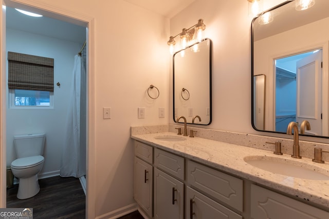 bathroom featuring vanity, hardwood / wood-style floors, toilet, and walk in shower