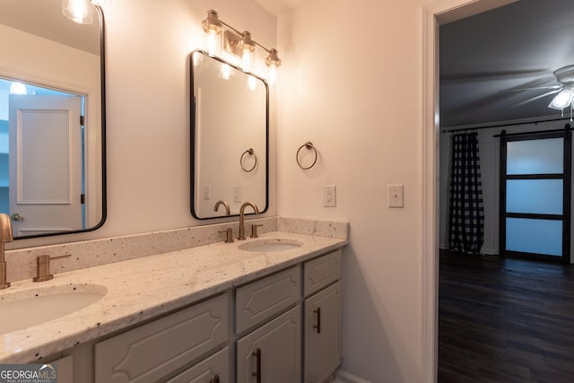 bathroom featuring hardwood / wood-style flooring, vanity, and ceiling fan