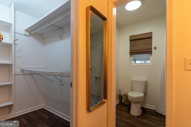 spacious closet with dark wood-type flooring