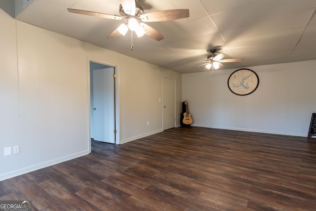 unfurnished room featuring dark hardwood / wood-style floors and ceiling fan