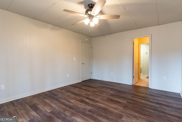 empty room featuring ceiling fan and dark hardwood / wood-style flooring