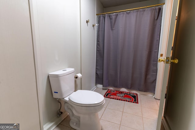 bathroom with tile patterned floors, toilet, and walk in shower