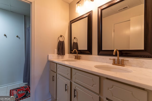 bathroom featuring tile patterned flooring and vanity