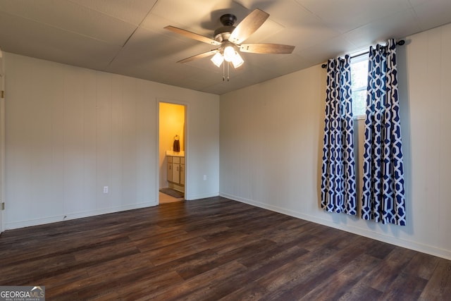 spare room with ceiling fan and dark hardwood / wood-style floors