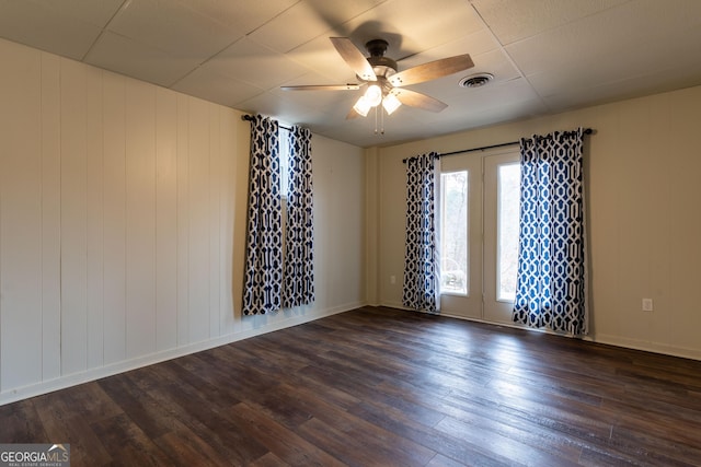 empty room featuring ceiling fan and dark hardwood / wood-style flooring