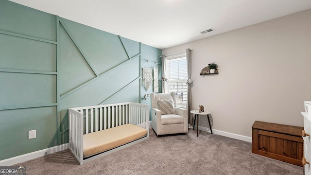 bedroom with a crib and carpet