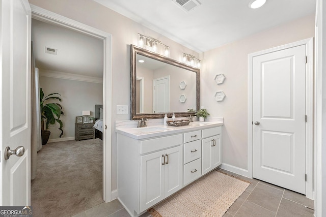 bathroom featuring tile patterned floors, vanity, and crown molding