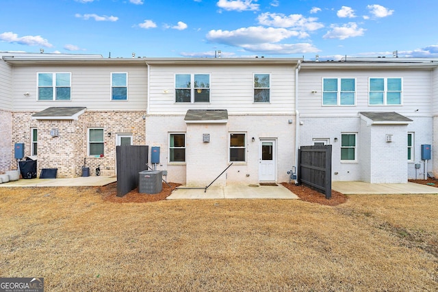 back of property featuring a patio, a lawn, and central AC unit