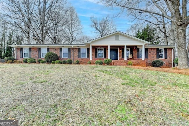 ranch-style house featuring a porch and a front yard