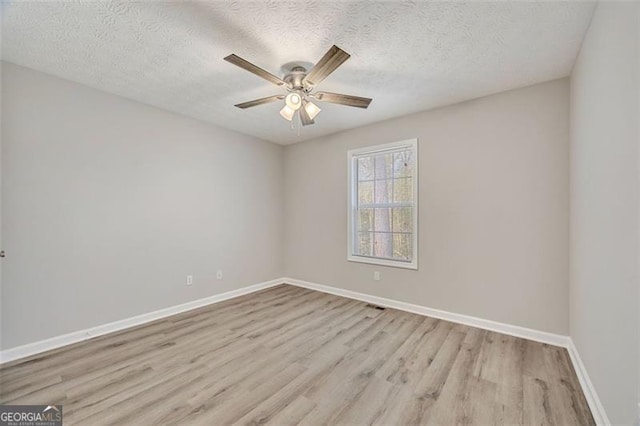 spare room featuring ceiling fan, a textured ceiling, and light hardwood / wood-style floors