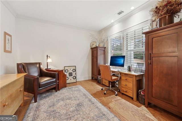 home office featuring crown molding and light hardwood / wood-style floors