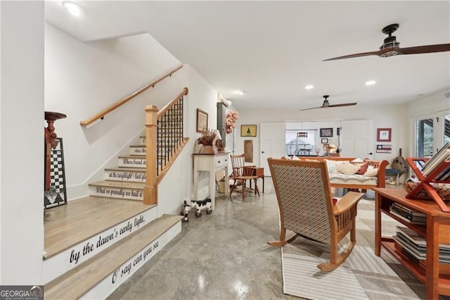 dining space featuring concrete floors and ceiling fan