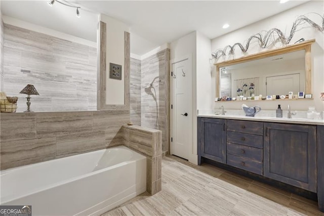 bathroom with vanity and a tub