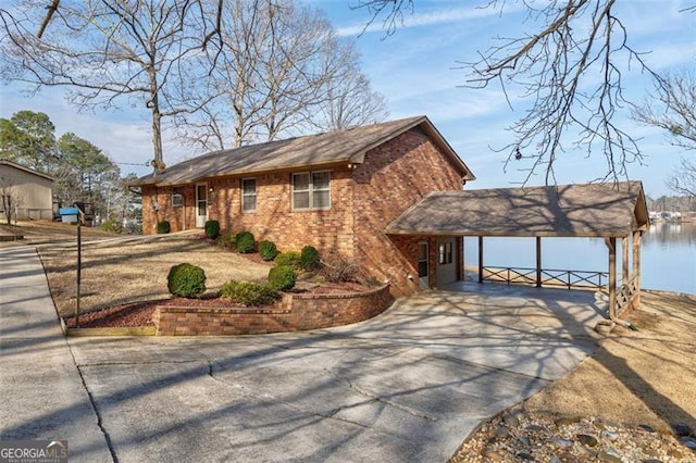 exterior space featuring a carport and a water view