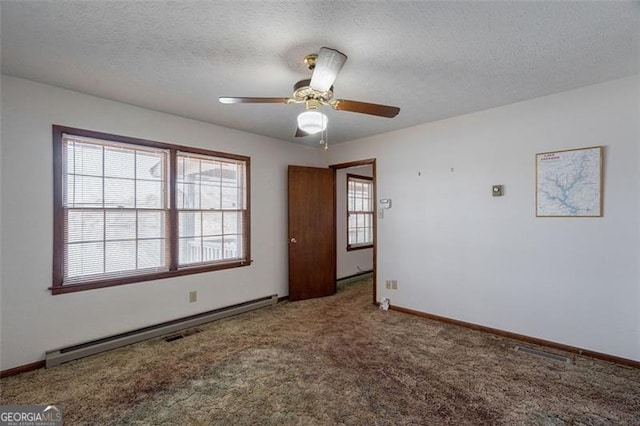 242 Herring Gull Ct, Monticello, GA 31064 - carpeted spare room with a baseboard radiator, ceiling fan, and a textured ceiling