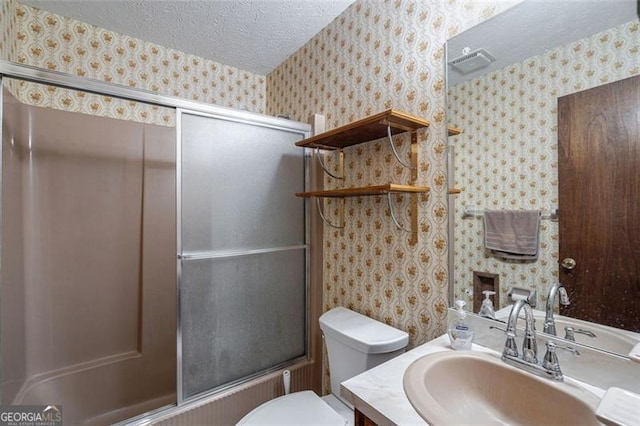242 Herring Gull Ct, Monticello, GA 31064 - full bathroom featuring vanity, enclosed tub / shower combo, toilet, and a textured ceiling