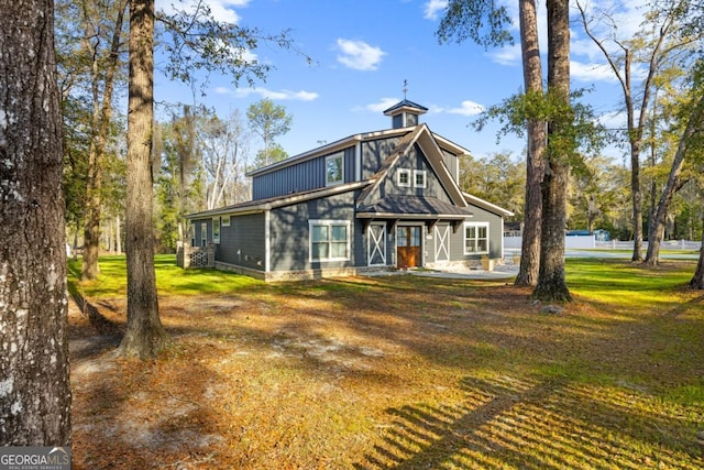 back of property featuring a lawn