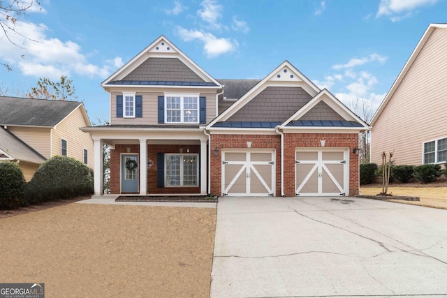 view of front of property featuring brick siding, a porch, concrete driveway, a standing seam roof, and a garage