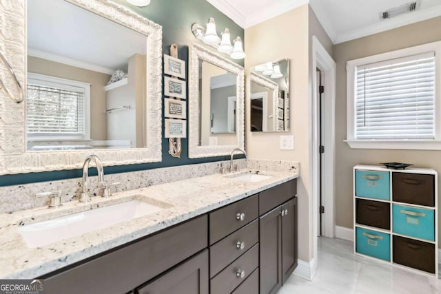 bathroom featuring crown molding and vanity