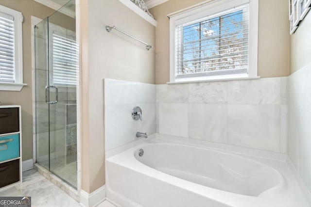 bathroom featuring crown molding and separate shower and tub