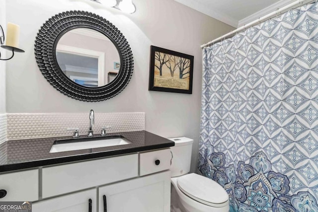 bathroom featuring vanity, ornamental molding, and toilet