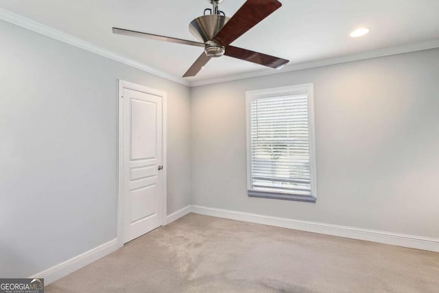 carpeted empty room featuring crown molding and ceiling fan