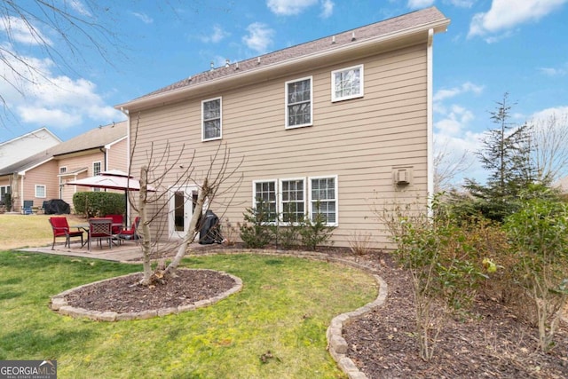 rear view of property with a gazebo, a yard, and a patio area