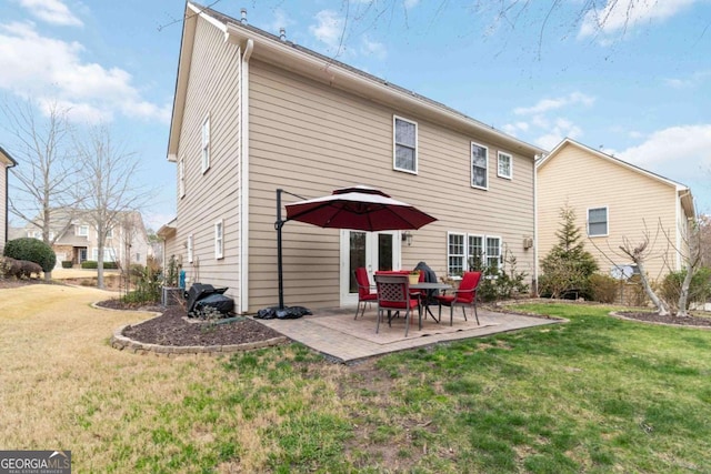 back of house with a patio and a yard