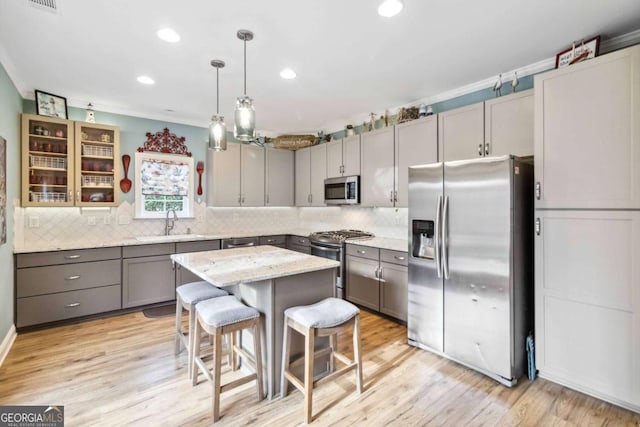7856 Keepsake Ln, Flowery Branch, GA 30542 - kitchen featuring stainless steel appliances, gray cabinets, a kitchen breakfast bar, tasteful backsplash, and recessed lighting
