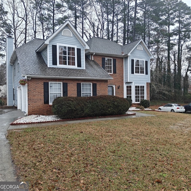 front of property featuring a garage and a front lawn