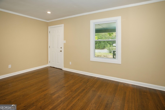 unfurnished room featuring dark wood-type flooring and ornamental molding