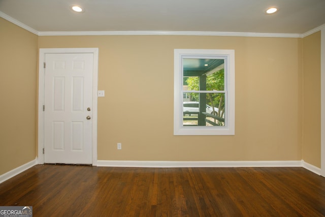 empty room with dark hardwood / wood-style flooring and ornamental molding