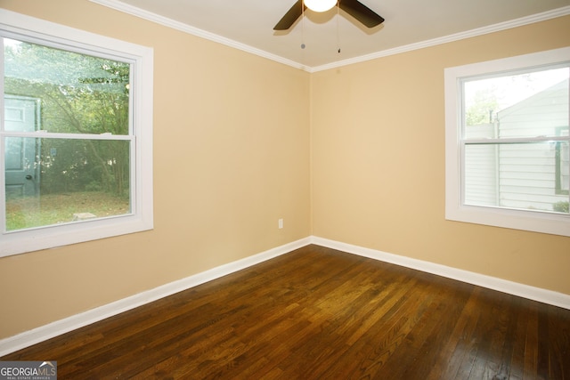 empty room featuring crown molding, dark wood-type flooring, and ceiling fan