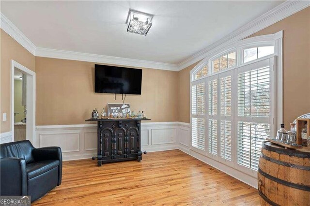 3130 Kates Way NW, Kennesaw, GA 30152 - living area featuring crown molding, light wood finished floors, and wainscoting