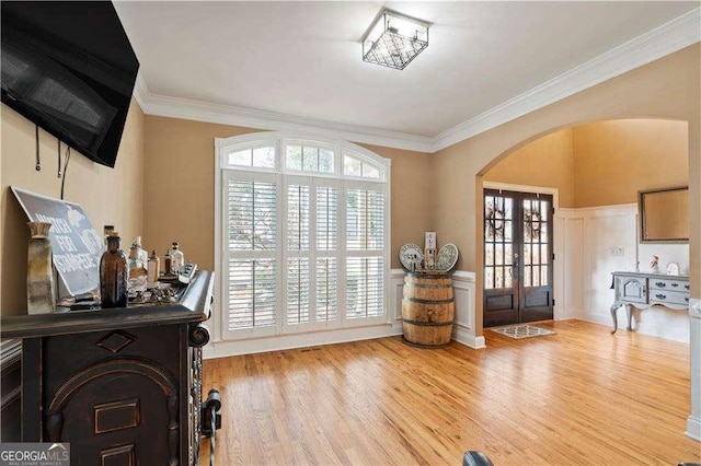 3130 Kates Way NW, Kennesaw, GA 30152 - foyer with arched walkways, wood finished floors, a decorative wall, crown molding, and wainscoting