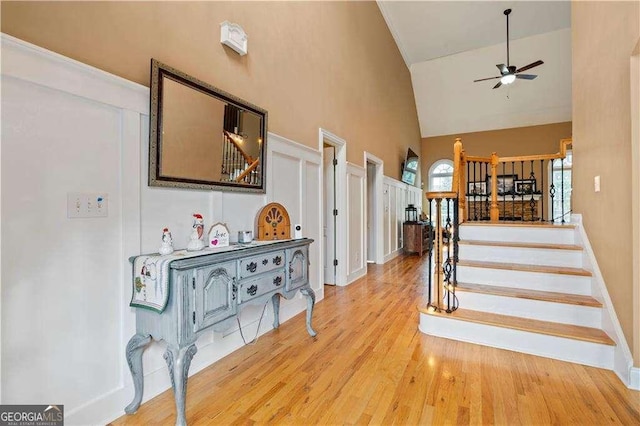 interior space with ceiling fan, wood-type flooring, and high vaulted ceiling