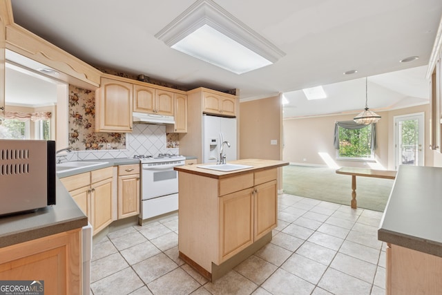 kitchen with crown molding, white appliances, light brown cabinetry, under cabinet range hood, and a sink