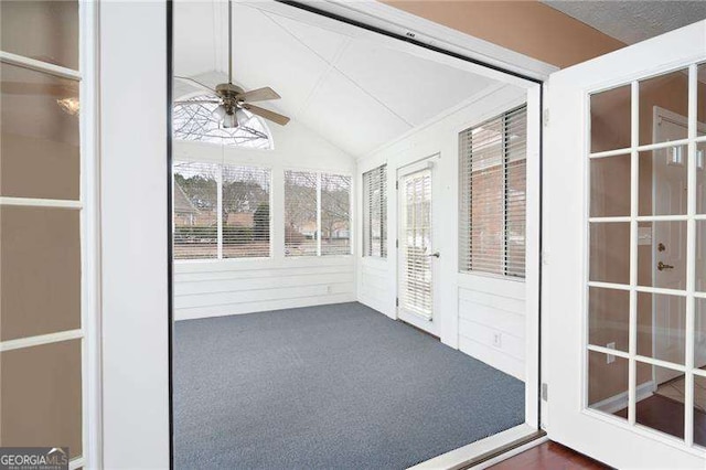 unfurnished sunroom with vaulted ceiling and ceiling fan