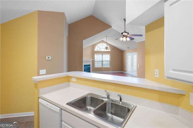 kitchen featuring lofted ceiling, sink, white cabinetry, dishwasher, and kitchen peninsula