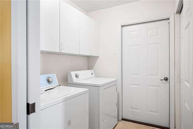 laundry area featuring cabinets and washing machine and dryer