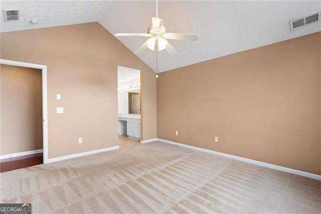 interior space with high vaulted ceiling, light carpet, a textured ceiling, and ceiling fan