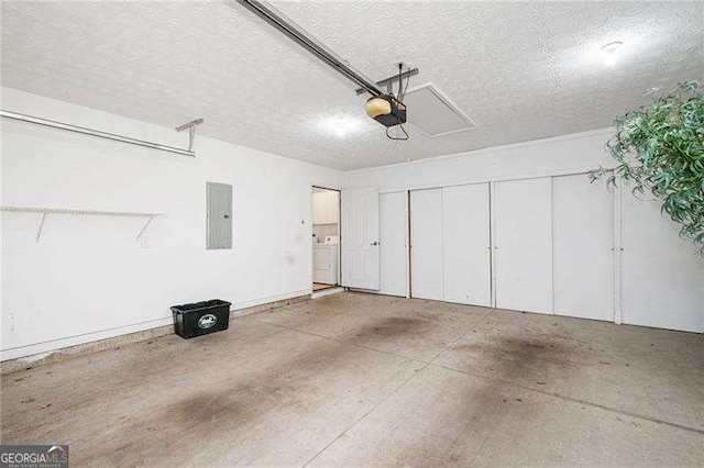 garage with washer / clothes dryer, a garage door opener, and electric panel