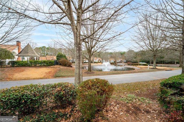 view of yard featuring a water view and a gazebo