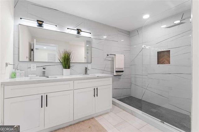 bathroom with vanity and tiled shower