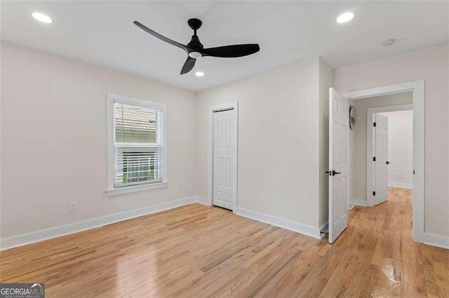 unfurnished bedroom with ceiling fan, light hardwood / wood-style floors, and a closet