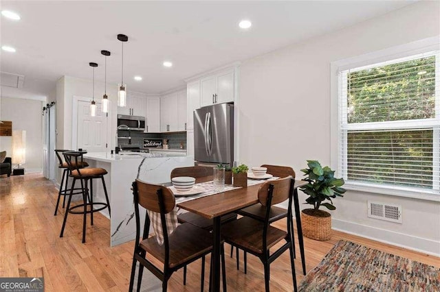 dining area with light wood-type flooring