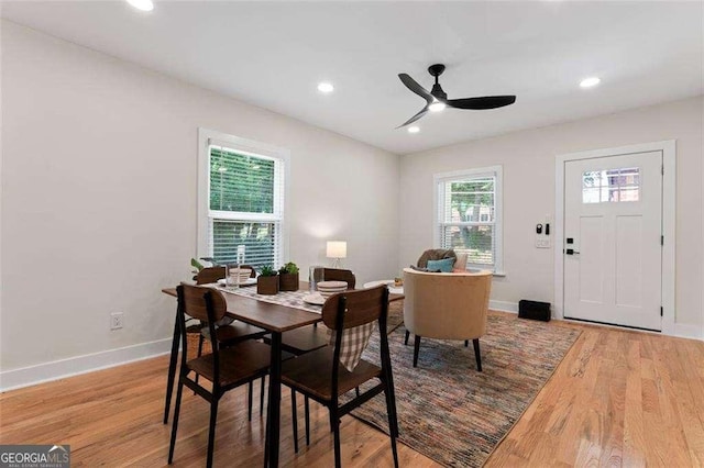 dining room featuring light hardwood / wood-style flooring, a wealth of natural light, and ceiling fan