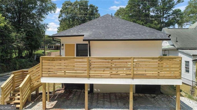 back of property with a wooden deck