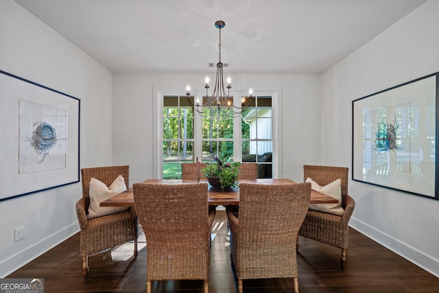 dining space featuring an inviting chandelier and dark hardwood / wood-style floors