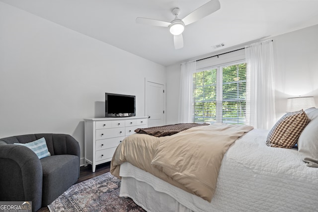 bedroom with ceiling fan and dark hardwood / wood-style flooring